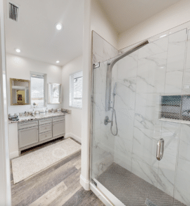 Full sized bathroom with white shower and sink